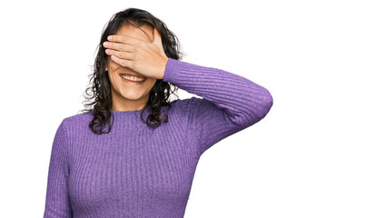 Young hispanic woman wearing casual clothes smiling and laughing with hand on face covering eyes for surprise. blind concept.