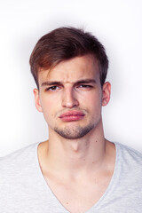 Obraz premium young handsome teenage hipster guy posing emotional, happy smiling against white background isolated, lifestyle people concept