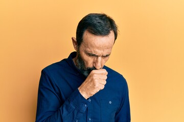 Middle age hispanic man wearing casual clothes feeling unwell and coughing as symptom for cold or bronchitis. health care concept.