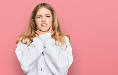 Beautiful young caucasian girl wearing casual sweatshirt shouting and suffocate because painful...