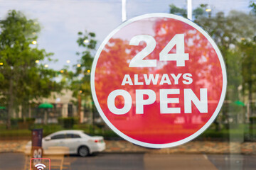 24 Hours Always Open Sign in front of the coffee shop cafe or co-working space in the town. 24...