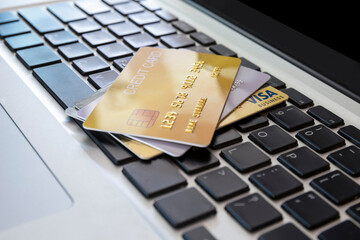 Close up Credit card on laptop of business workplan. many credit card on laptop keyboard of online shopping payment. Credit card payment for purchases from online stores and online shopping,