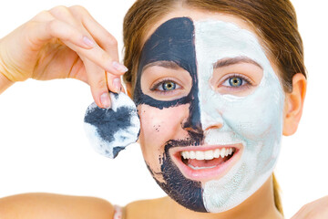 Girl remove black white mud mask from face