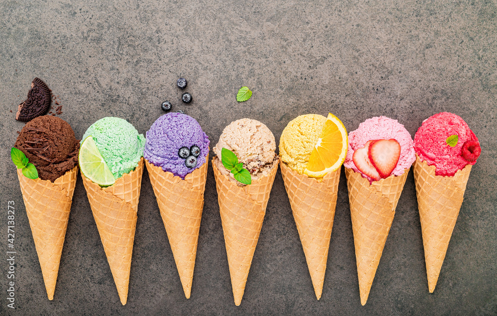 Poster flat lay ice cream cones collection on dark stone background . blank crispy ice cream cone with copy