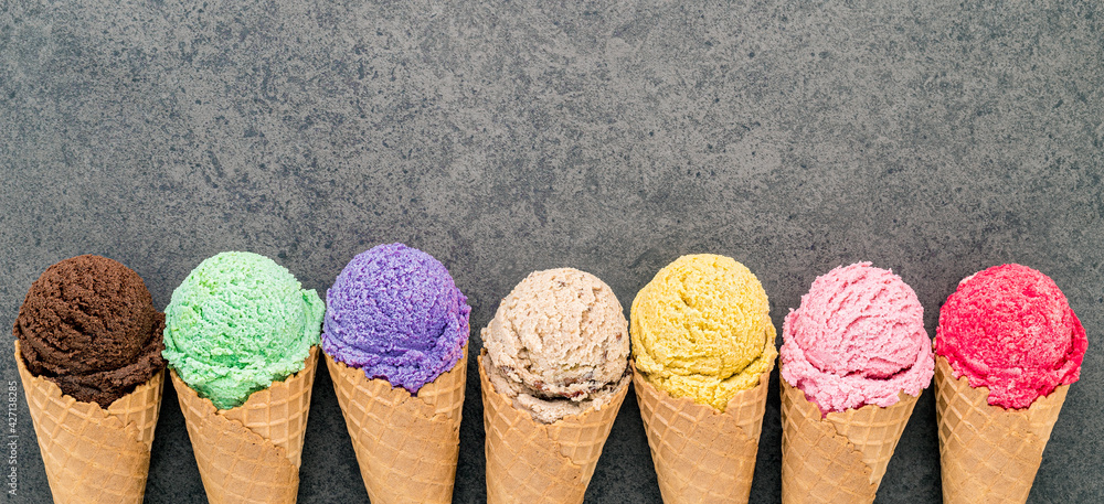Poster Flat lay various of ice cream cones set up on dark stone background  . Summer and Sweet menu concept.