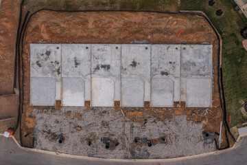 Aerial view of the concrete foundation basement of luxury single family homes at a new development neighborhood construction site in Maryland USA