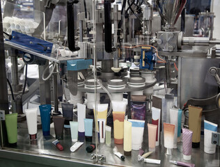Process of automatic cosmetic tubes filling and sealing machine. Pharmaceutical industry