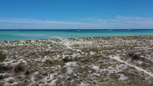 Drone Aerial View of Intact Tropical Coastline Anchored Boats and People Walking in Shallow Turquoise Water. Dunsborough, Margot River Region, Australia