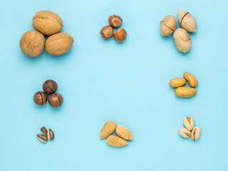The frame is made of various nuts, stacked in three pieces. Flat lay.