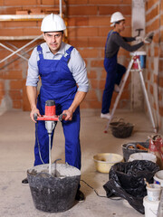 Portrait of two professional builders in process of repair at private house