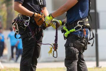 Fire fighters to prepare climbing equipment For use in rescue missions