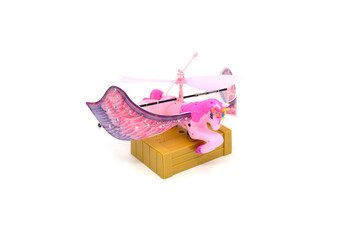 Plastic flying pink toy unicorn isolated in white background.