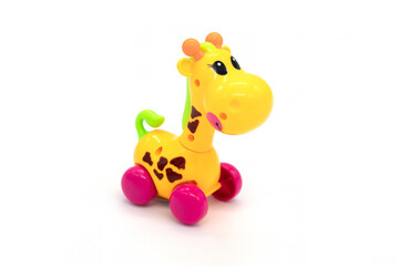Plastic yelow toy giraffe on a white background.