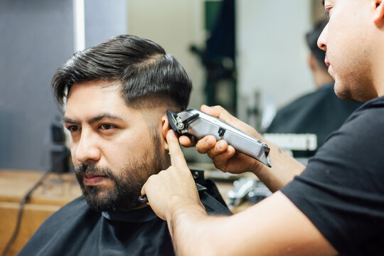 Man Getting His Hair Cut In A Barbershop