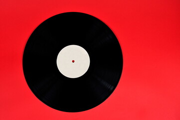 Vintage vinyl record on a red background.