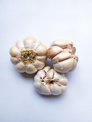 three fresh and raw garlic isolated on white background.