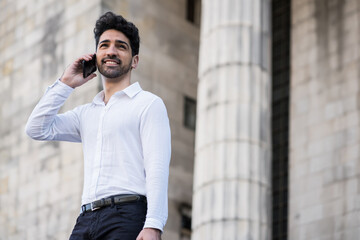 Businessman talking on the phone outdoors.