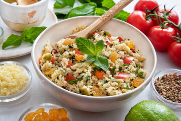 Close-up of a tabbouleh dish with surrounding ingredients