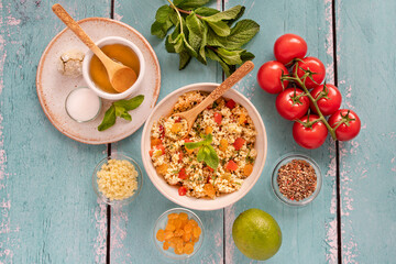 Close-up of a tabbouleh dish with surrounding ingredients