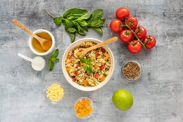 Close-up of a tabbouleh dish with surrounding ingredients