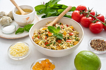 Close-up of a tabbouleh dish with surrounding ingredients