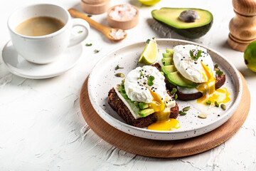 Sandwich with avocado and poached egg. Healthy nutritious paleo keto breakfast concept