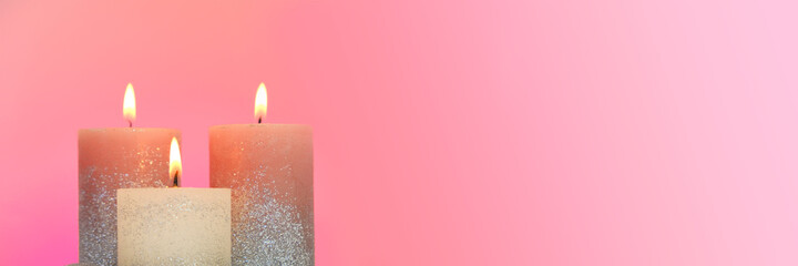 Candles set banner . Festive glitter candles on a  pink Background. Candle flame. Copy Space.Online candle shop banner. 
Festive shiny candles banner. Religion and culture 