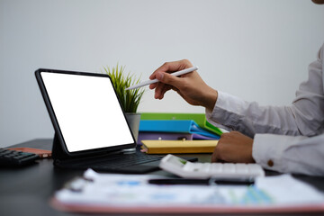 Cretive man in white dress smiling holding stylus pencil and coffee in home office. Work from home...