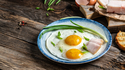 Traditional Ukrainian or belorussian food. Breakfast, lunch bacon, lard fried eggs and toast on old wooden table. banner, catering menu recipe place for text, top view