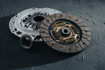 Automotive clutch mechanism, disc, basket and bearing for auto on a black background.