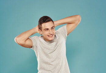 Handsome man in white t-shirt studio lifestyle blue background