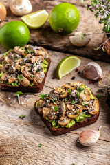 Toast avocado, mushrooms and microgreen whole grain sandwich. Decorated with sesame. Vegetarian food. Vegan menu. vertical image, place for text