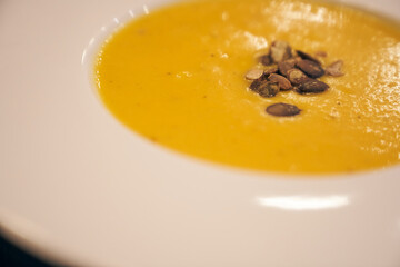 Pumpkin soup in a restaurant, cafe. Delicious food. A healthy lunch. High quality photo