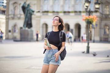Fototapeta premium New adventure. Woman on street with map in hands.
