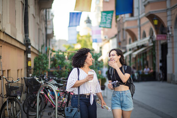 Two tourist women on street.