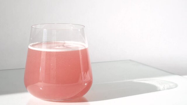 Super food. Natural strawberry collagen protein powder in glass of water for face lifting and skin regeneration. Trendy food additives. Healthy and anti age concept.