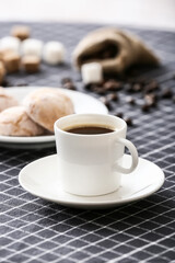 Cup of hot coffee on table in cafe