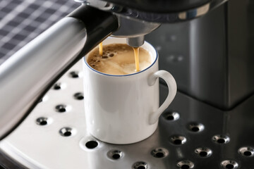 Modern coffee machine with cup of hot espresso in cafe, closeup