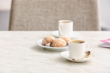 Cup of hot coffee on table in cafe