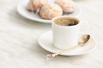 Cup of hot coffee on table in cafe