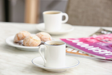 Cup of hot coffee on table in cafe