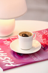 Cup of hot coffee on table in cafe