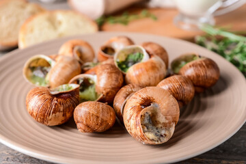 Plate with tasty snails, closeup