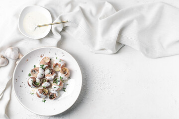 Obraz na płótnie Canvas Plate with tasty snails on light background
