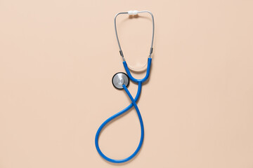 Modern stethoscope on color background