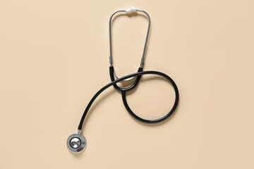 Modern stethoscope on color background