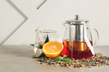 Composition with teapot and dry leaves on table