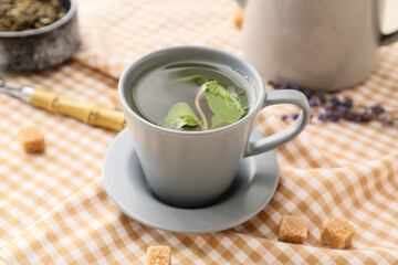 Cup of green tea on table