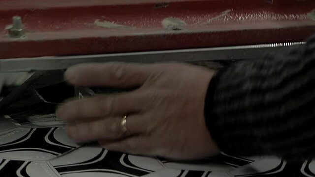  Old Worker Hand cutting Pieces of Synthetic Hexagons and Pentagons at a Football Ball Factory. Close Up.