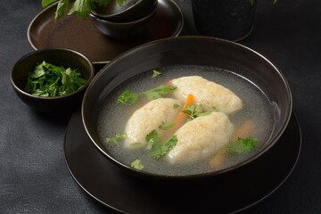 Griessnockerlsuppe. Clear Soup with Semolina Dumplings in a bowl. German food. Bavarian cuisine.